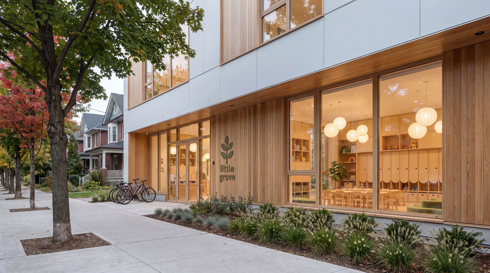 Contemporary neighbourhood childcare centre with warm wood cladding, generous glazing, and landscaped street frontage